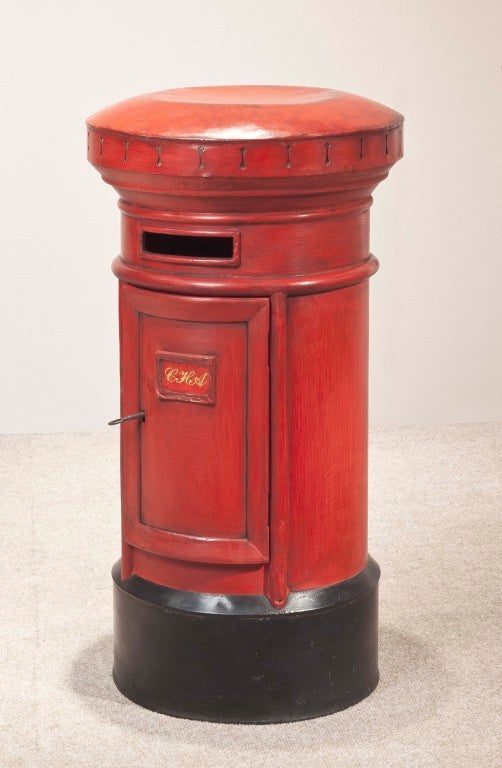 A red-painted model of a post box.