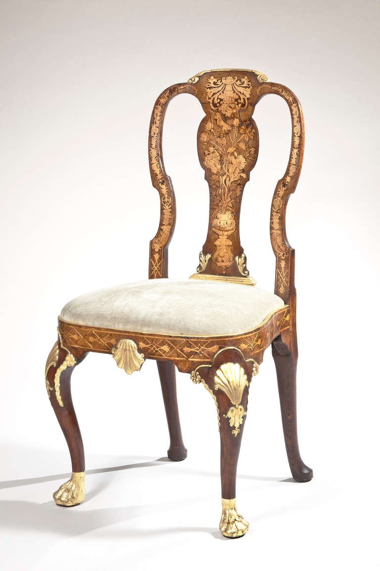 A rare Anglo-Dutch walnut and marquetry side chair with marquetry in the crest rail, styles, splat and seat rails, with carved cabriole parcel gilt legs, having shells on the knees, terminating in hairy paw feet. Re-gilt.
Literature: Beard,