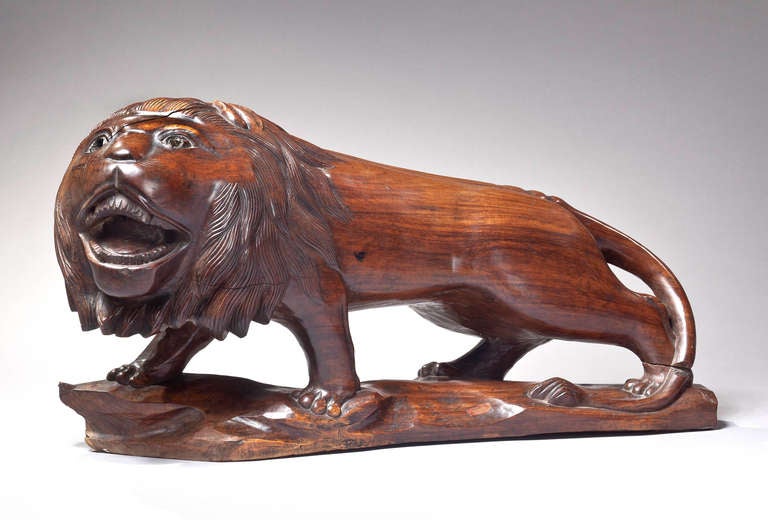 A carved rosewood lion, possibly Indian