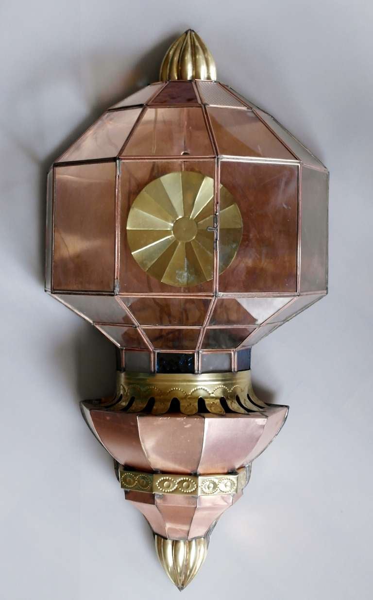 Being offered is a circa 1975 wall sconce made in Mexico, lantern style formed of copper with gilded finial & embossed trim; original glass panels. Sconce is not electrified. More sconces are available. Dimensions 30" length x 14"