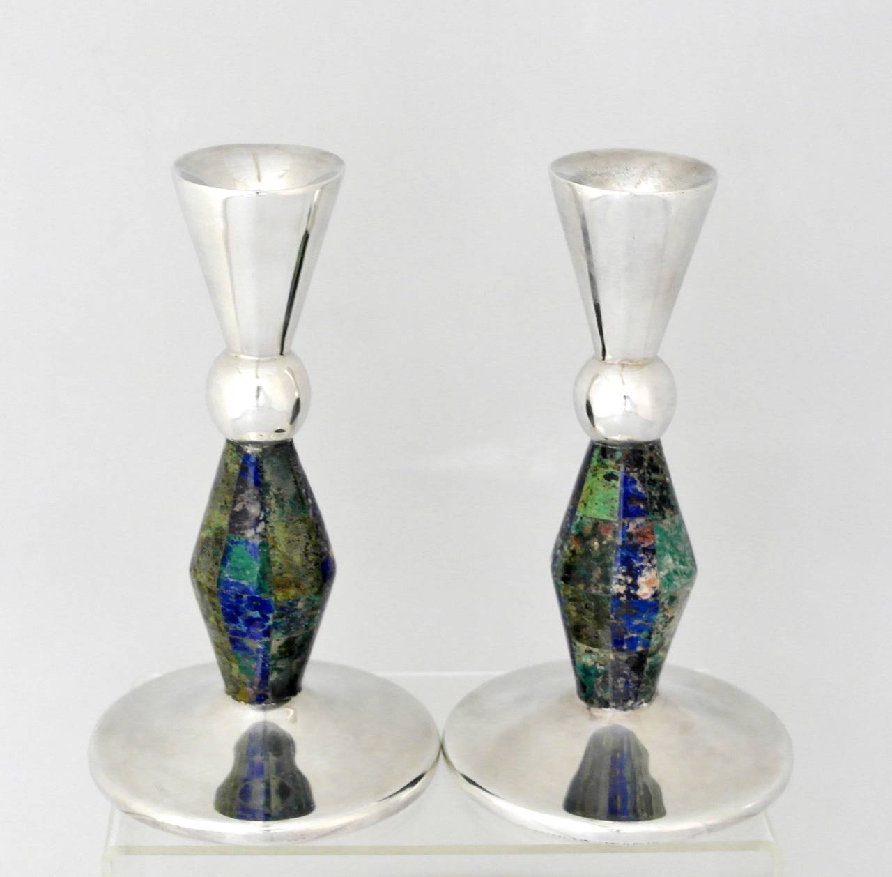 Being offered are a pair of candlesticks by Los Castillo of Taxco, Mexico. Handwrought pair with azur malachite & lapis lazuli stone inlay at the stems. Dimensions: 7 inches x 4 inches diameter at the base. Marked as illustrated. In excellent