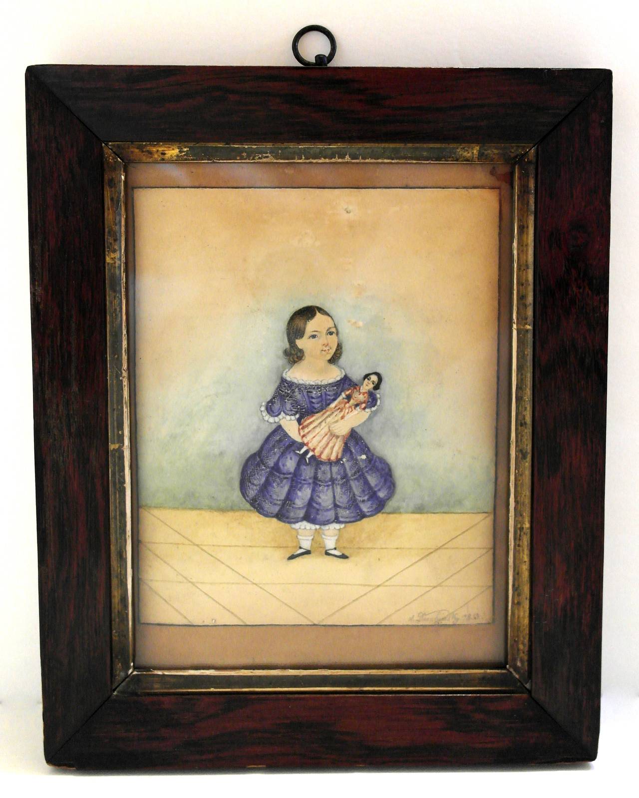 Being offered is a circa 1853 American Folk Art portrait of a young girl in a blue dress. Rare early example with artist using pencil, watercolor and oil, all rendered on paper. Young girl standing while holding her favorite doll. A well executed
