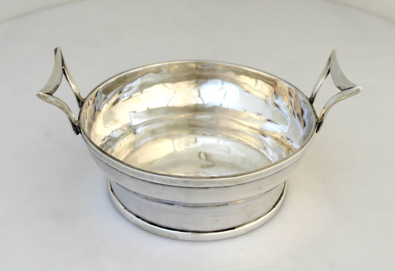 Being offered is a circa 1973 sterling silver bucket by Henry Petzal, of circular form with applied double handles, entirely hand-wrought. Number five of eight made by Petzal. Dimensions 6 1/4" diameter x 2 1/4" height. Weight a hefty 18
