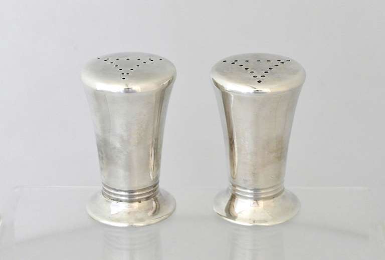 Being offered are a pair of circa 1950 salt & pepper shakers by Porter Blanchard of California. Entirely hand made pieces, of tapered form with three embossed bands near the pedestal base. Dimensions: 3
