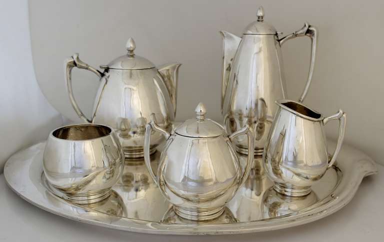 Being offered is a circa 1963 sterling silver coffee and tea set by Aceves of Mexico; of bulbous form with angular handles and tear drop finials. Includes matching serving tray. An incredible modernist set. Dimensions: pots - 10