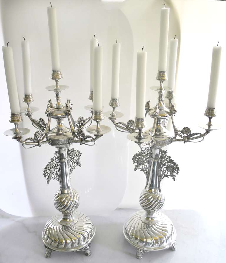 Being offered is a circa 1885 pair of monumental candelabra by Meriden Silver Plate Co. of Meriden, Connecticut, the domed bases chased with sweeping lobes,the baluster stems with pierced buttress supports, tops with four scroll branches.  Height