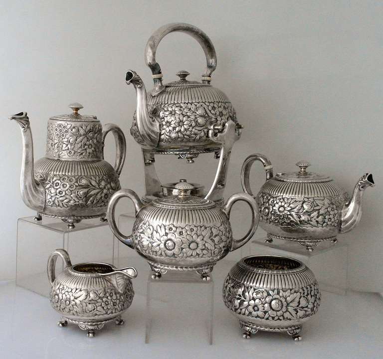 Being offered is a fine circa 1880 silverplate tea & coffee service by Gorham, of Providence, Rhode Island, profuse floral repousse work and a striated design on each piece, the original ivory insulators are intact. Dimensions: kettle - 12 inches