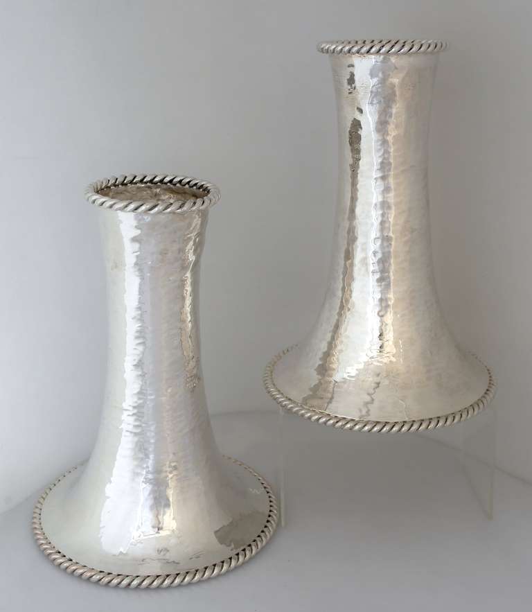 Being offered are a pair of circa 1990 silver plate vases by Emilia Castillo of Taxco, Mexico, with all-over spot hammering, with applied rope rim at base and upper rim. Dimensions: 12 inches high; upper rim 4 1/4 inches diameter; base 8 1/2 inches