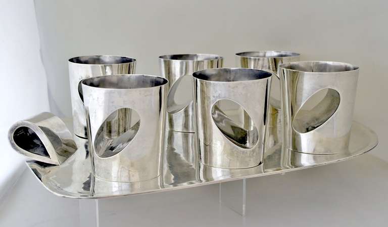 Being offered is a circa 1955 sterling silver six tumbler set with tray by Antonio Pineda of Taxco, Mexico, in a most futuristic motif, with cut-out as photographed. Construction is superb. Very heavy gauge of silver. Dimensions of tumbler 4 3/4