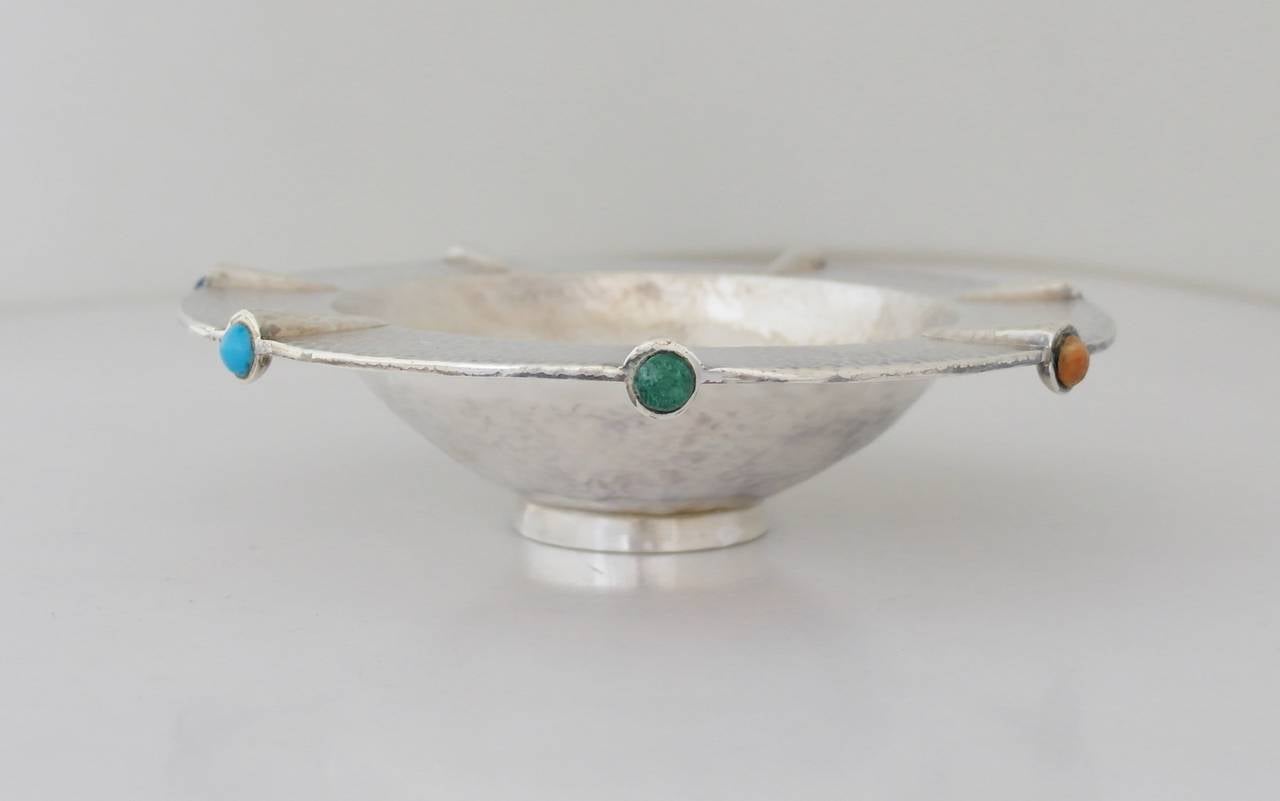 Being offered is a sterling silver bowl by Emilia Castillo of Taxco, Mexico. Hand wrought pedestal footed bowl with natural lapis lazuli, turquoise and agate cabochons within 7 lobes. Dimensions: 7 1/2