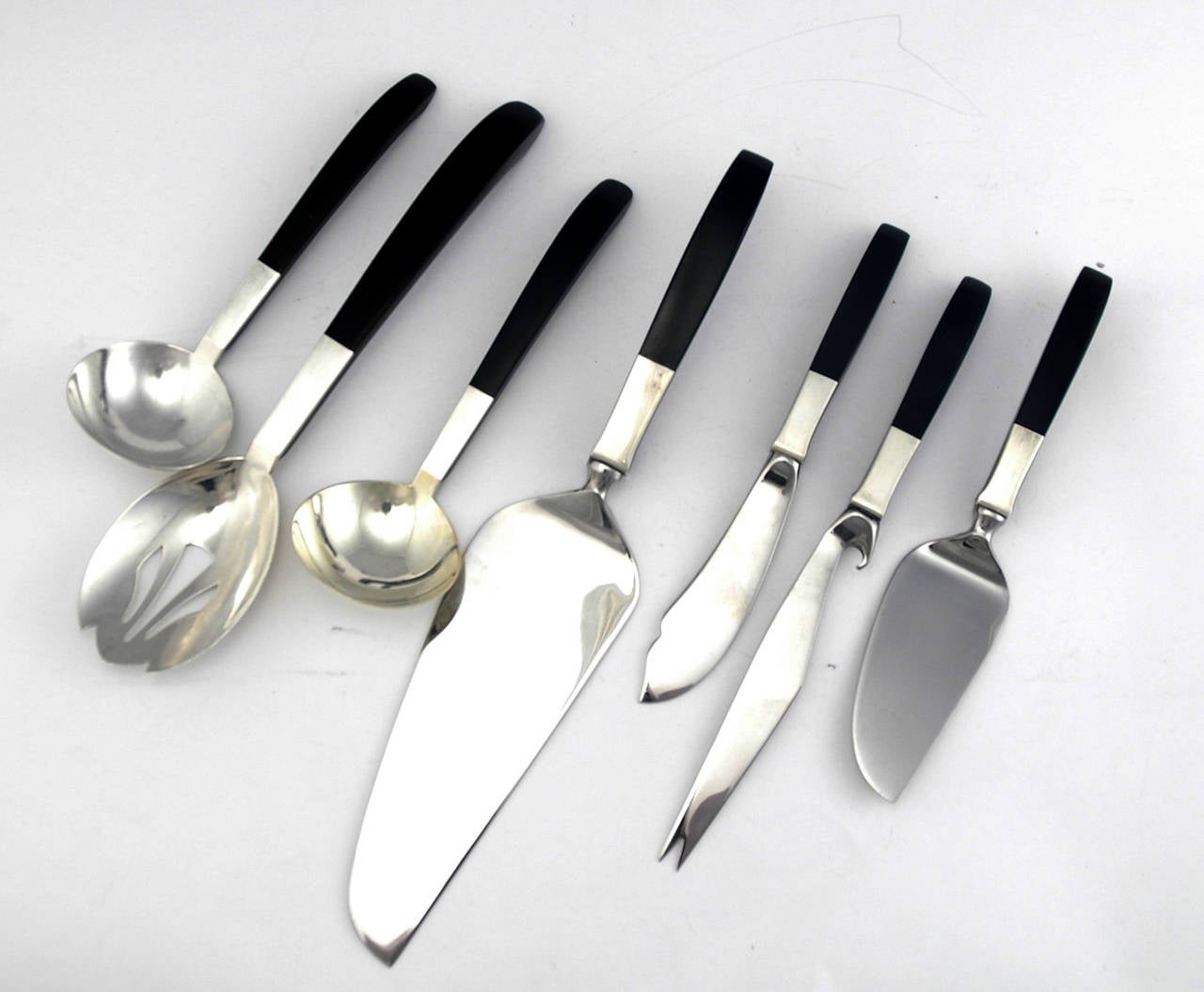 Being offered is a fine, circa 1956 sterling silver flatware set designed by Nord Bowlen for Lunt, of Greenfield, MA, using black nylon handles as a glorious counterpoint to sterling silver and emphasizing the combination of silver and plastics in
