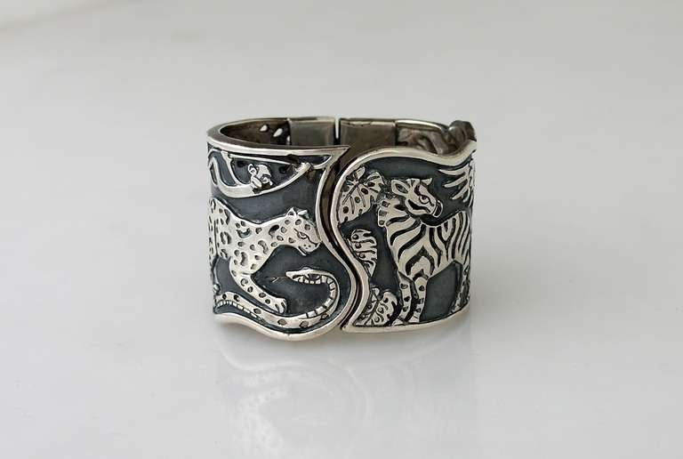 Being offered is a fine sterling silver cuff by renowned Mexican silversmith (please see our other Emilia Castillo listings) Emilia Castillo of Taxco, Mexico, the 2 inch wide hinged cuff displays a high relief animal motif, the background surface