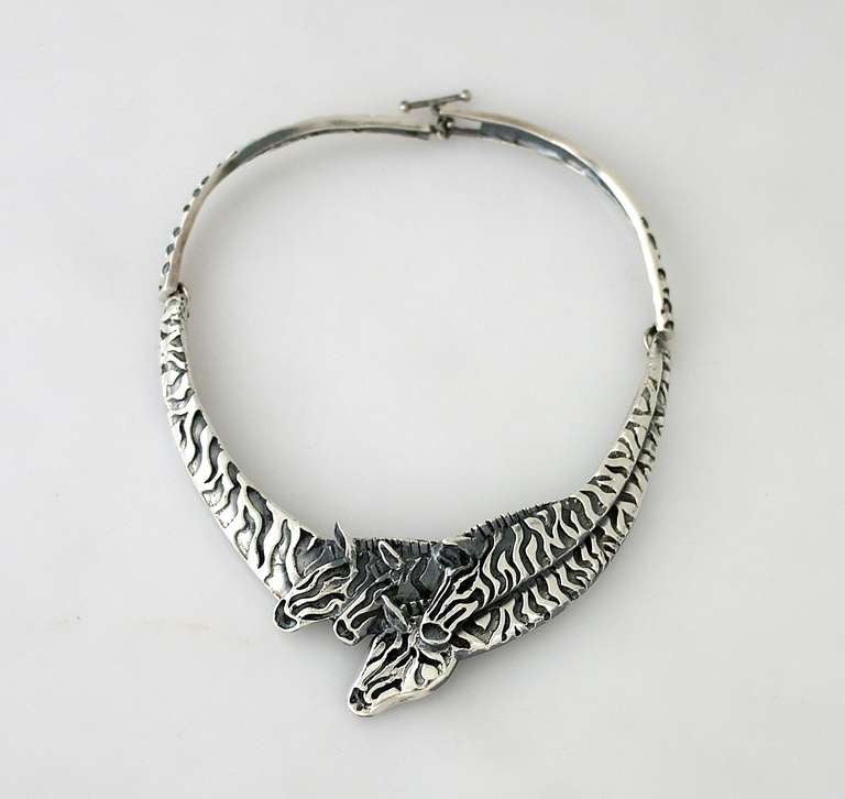 Being offered is a circa 1990 sterling silver necklace by renowned Mexican silversmith (please see our other Emilia Castillo listings) Emilia Castillo of Taxco, Mexico, the 1 3/4  inch wide hinged cuff displaying a group of zebras in high relief,
