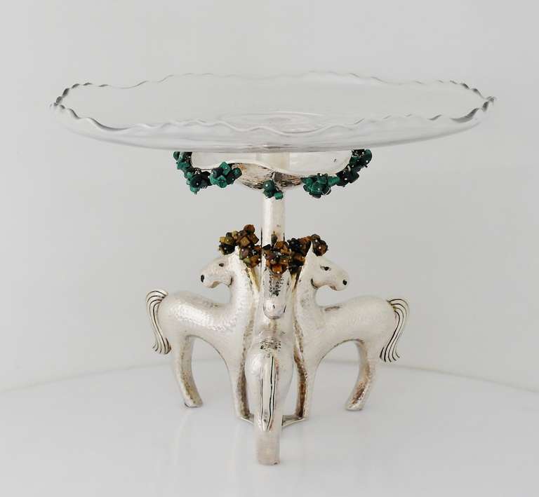 Being offered is a contemporary sterling silver centerpiece by Emilia Castillo of Taxco, Mexico. Unusual centerpiece featuring three figural mares facing outward with dangling tiger eye stones; hand-hammered texture throughout with additional