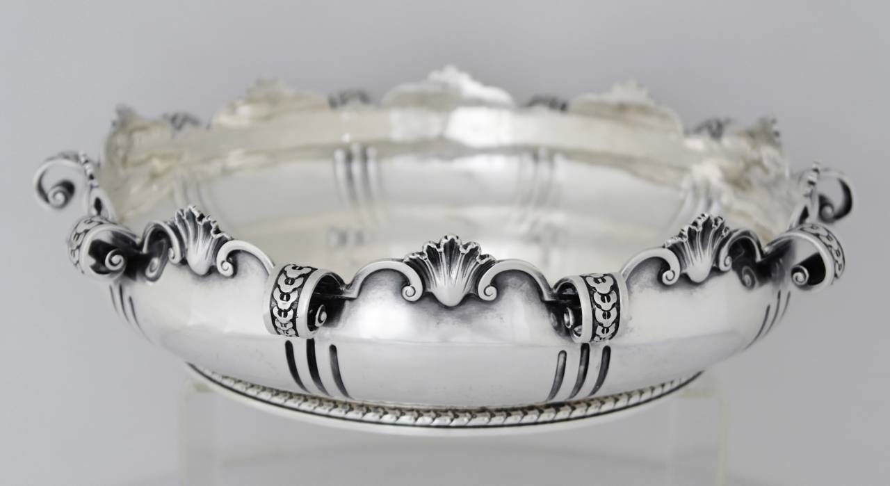 Being offered is a circa 1912 sterling silver bowl by William Comyns of London, England; impressive heavy gauge silver centerpiece manufactured for Tiffany, comprising shell & scroll design with 10 scroll motifs extending throughout the bowl;