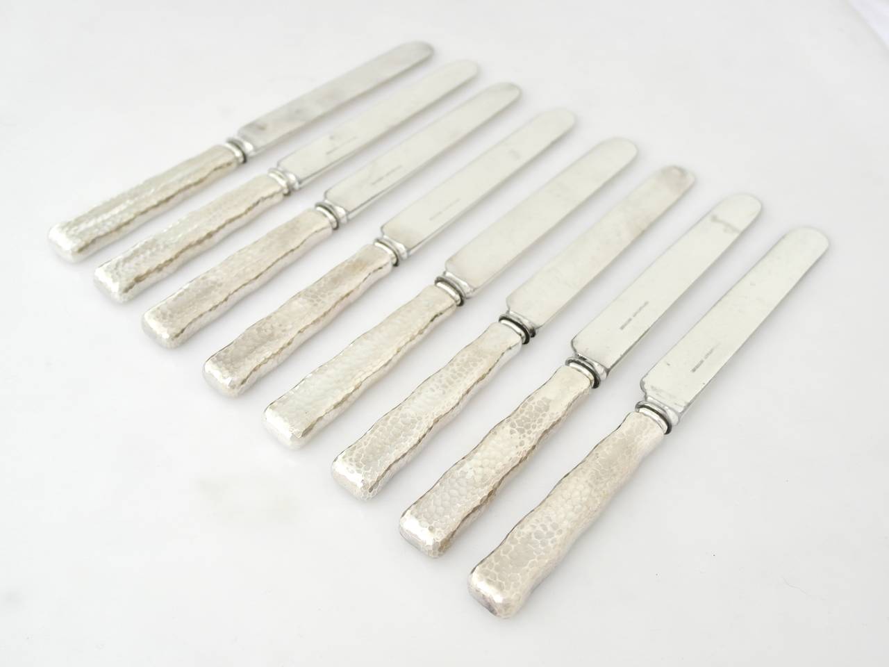 Being offered are a, circa 1880 sterling silver set of eight luncheon knives by Tiffany of New York, in the lap over edge hammered pattern.
More pieces are available in this pattern, including the dinner knives.
Dimensions: 9 1/8 inches. Marked as