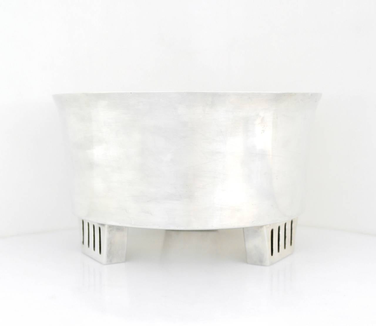 Being offered is a sterling silver bowl made in Mexico. Large centerpiece of modernist form resting on three trapezoid shaped feet with a pierced design as the primary decorative element. Very heavy object weighing 60 oz. Dimensions: a monumental 10