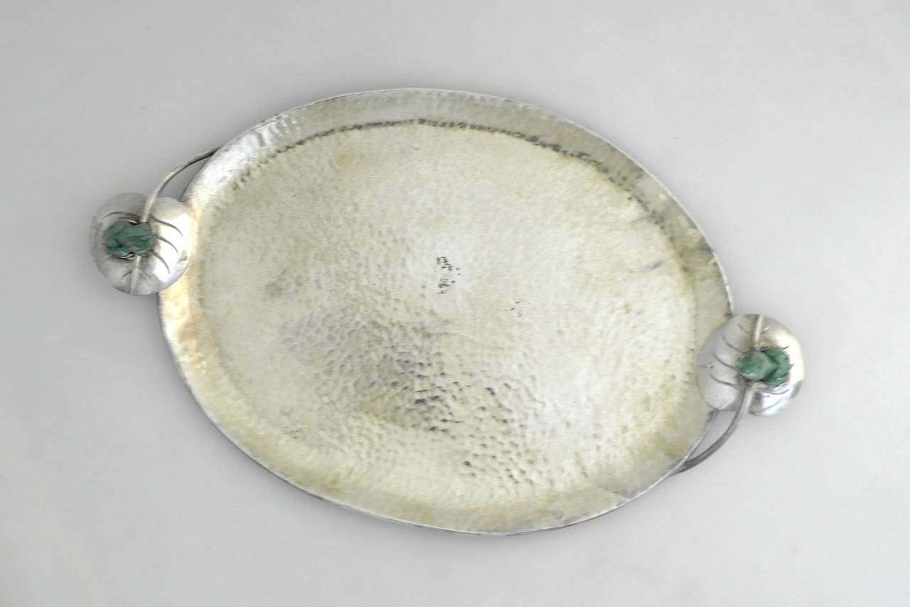 Being offered is a handmade silver plate serving tray by Emilia Castillo of Taxco, Mexico. Entirely handmade piece with lily pad handles holding three dimensional frogs carved from native stone. Dimensions: 14 1/2 inches long x 8 3/4 inches wide x 1