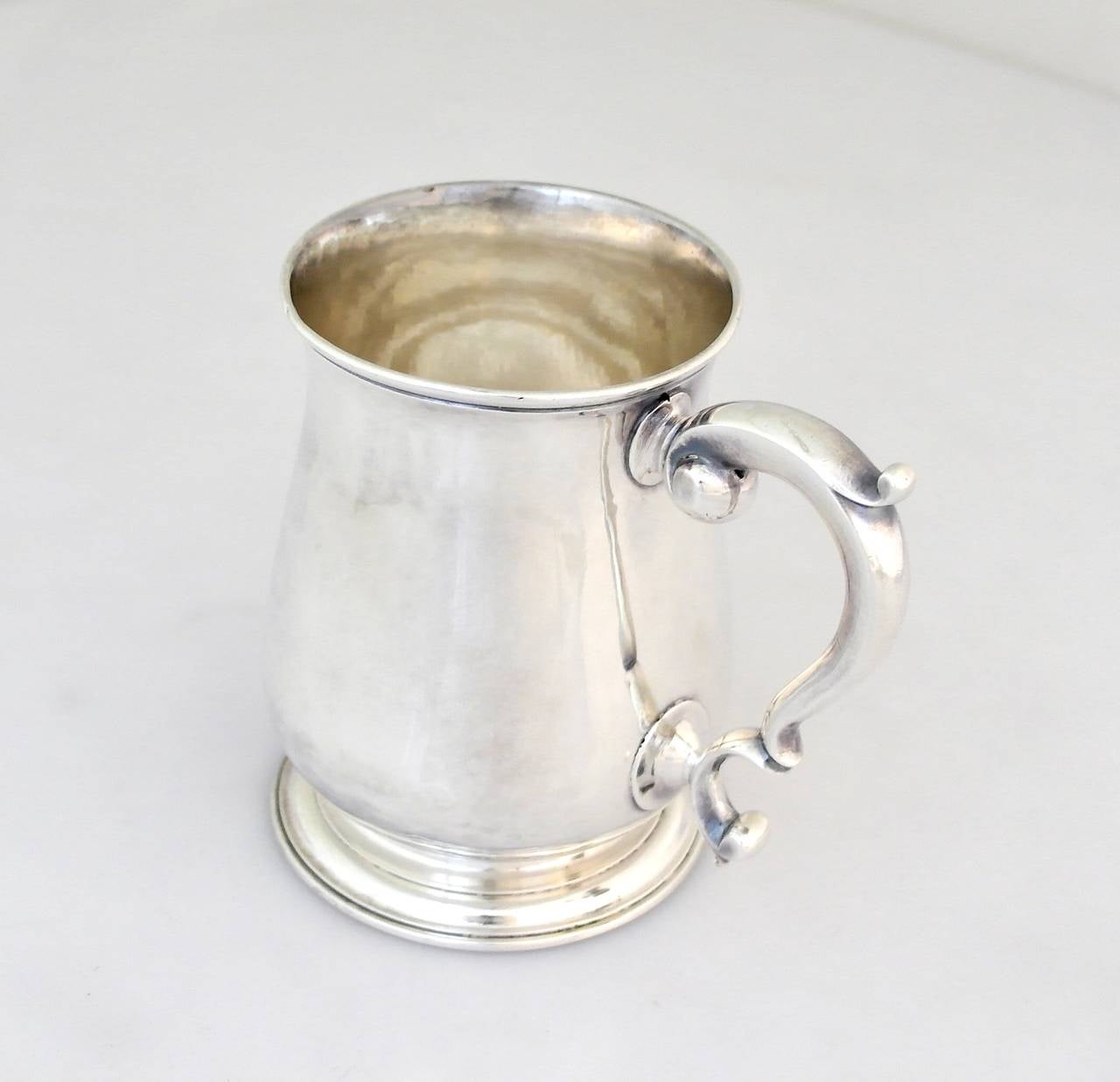 Being offered is a scarce, circa 1745 sterling silver tankard by Richard Bayley of London. Comprising a heavy gauge baluster form body with double scroll handle, on a raised circular foot. Dimensions: 4 3/4 inches height, 3 3/4 inches diameter at