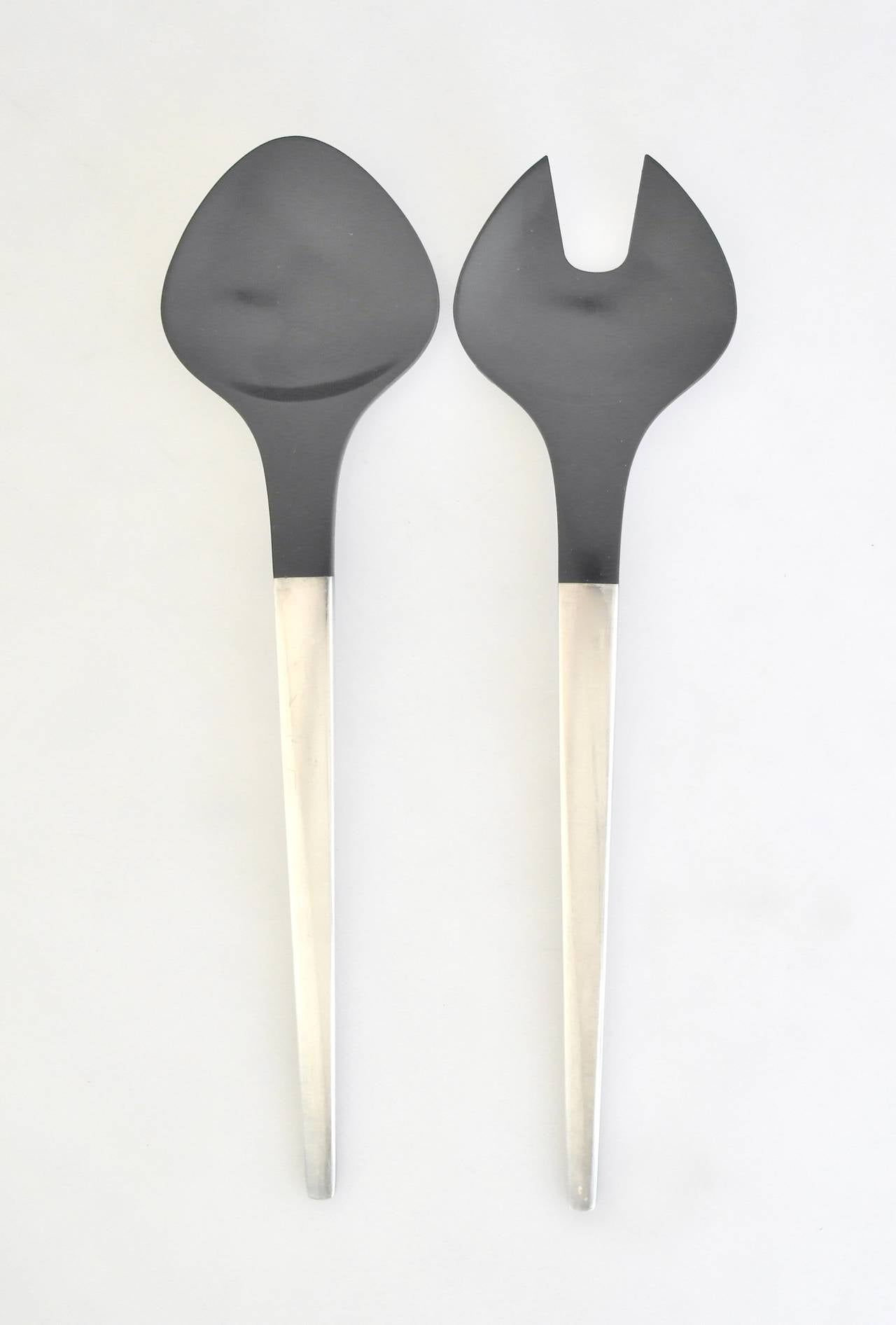 Being offered are pair of salad servers designed by Henning Koppel for Georg Jensen, comprising sterling silver handles extending to ebonized bakelite bowl and tines, in the sought after Caravel pattern, circa 1957. Dimensions: fork - 11 1/4
