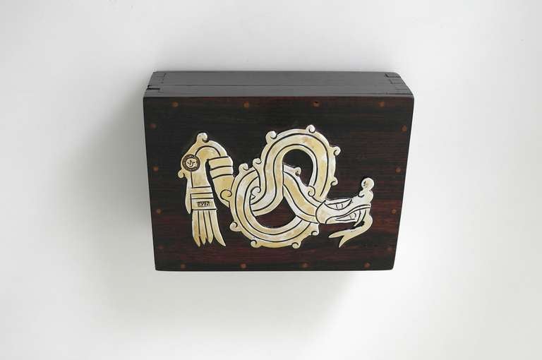 Being offered is a circa 1940 box by William Spratling of Taxco, Mexico; made during his first design period; rosewood box with applied sterling silver serpent of Aztec influence; detachable lid. Dimensions: 4 5/8