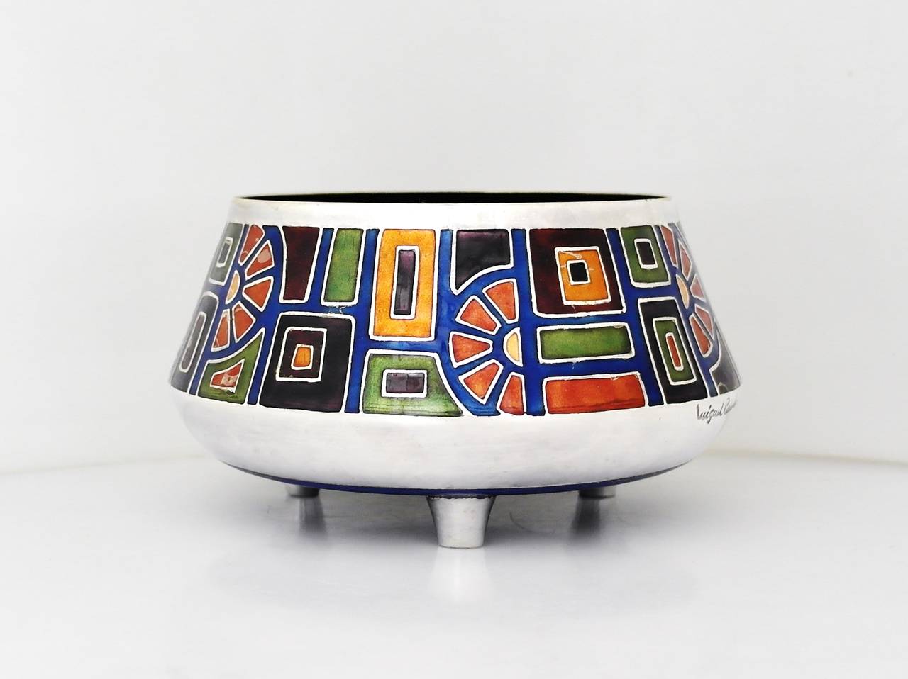Being offered is a circa 1955 silver plate bowl by Miguel Pineda of Mexico City. This incredible bowl is decorated with enameled geometric shapes in varying colors; enamel on the interior & underside; resting on three feet. Dimensions: 4 1/2