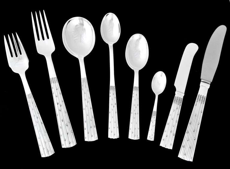 Being offered is a circa 1965 sterling silver flatware set by Danish silversmith, Orla Vagn Mogensen of Copenhagen, in the champagne pattern designed by Jens Harald Quistgaard.
The handles are vertically ribbed with applied 'dots' in the
