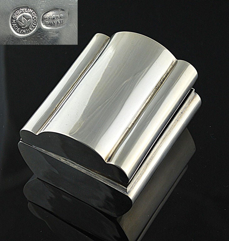 Being offered is a sterling silver fine box or purse -- an excellent example of the master craftsmanship and design of the pre-eminent atelier of William Spratling, the American who went to Taxco in 1929 and rejuvenated the Mexican silver industry