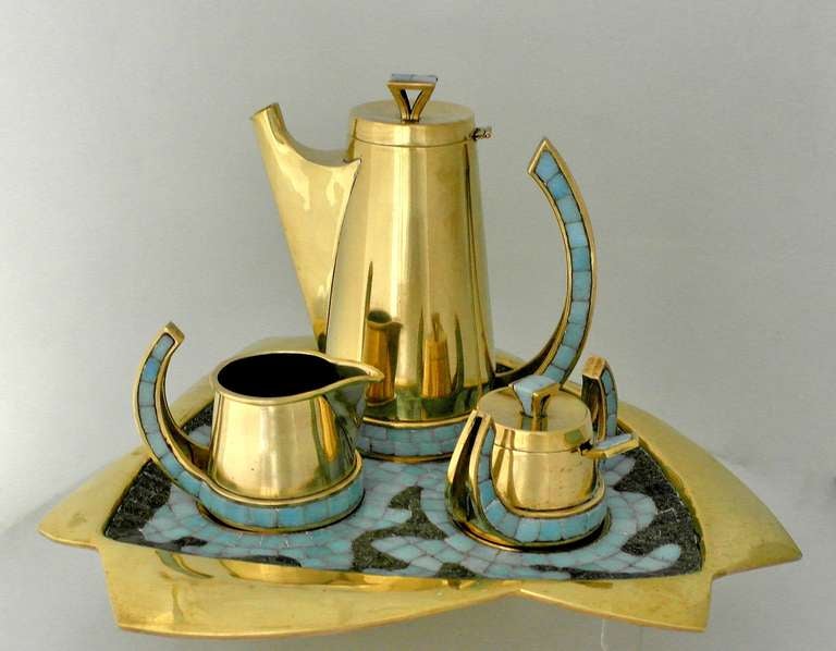 Being offered is a circa 1970s tea set by Salvador Teran of Taxco, Mexico, hand-wrought brass and glass mosaic tile coffee service includes coffee server, sugar bowl with lid and spoon, creamer and Tray. Marked. In excellent condition.
Dimensions