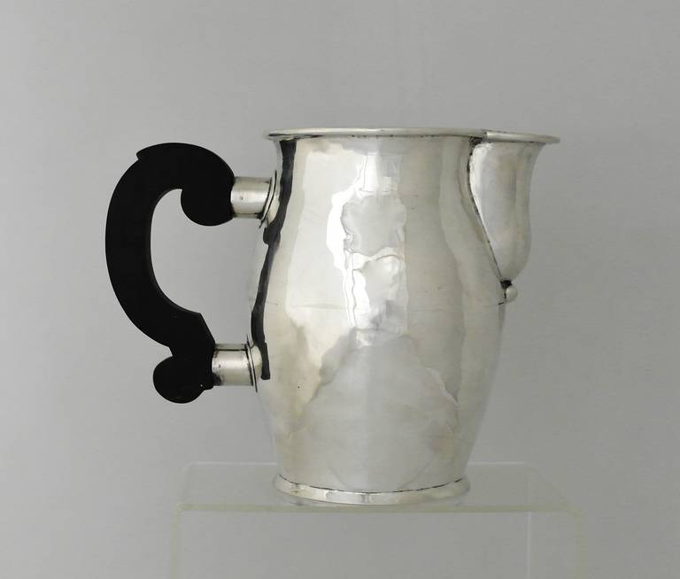 Being offered is a circa 1950 sterling silver pitcher by William Spratling of Taxco, Mexico, with a rolled rim and a squared rosewood handle, handmade.
Height 6 7/8 inches high, 8 3/4 inches over handle and spout. Fully marked. In excellent