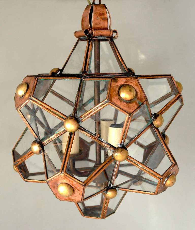Being offered is a scarce circa 1945 copper & brass chandelier by Hector Aguilar of Taxco, Mexico; entirely hand made, star shaped design with glass panels, the chandelier is electrified without compromising its integrity.  The 'Star Lantern' is