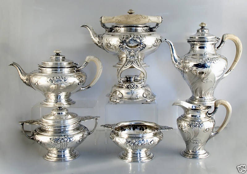 Desirable  circa 1899 Athenic motif sterling silver and ivory six (6) piece tea and coffee set with kettle on stand by Gorham, of Providence, RI, the background hand hammered, comprising coffee pot, teapot, sugar bowl with cover, cream pitcher,