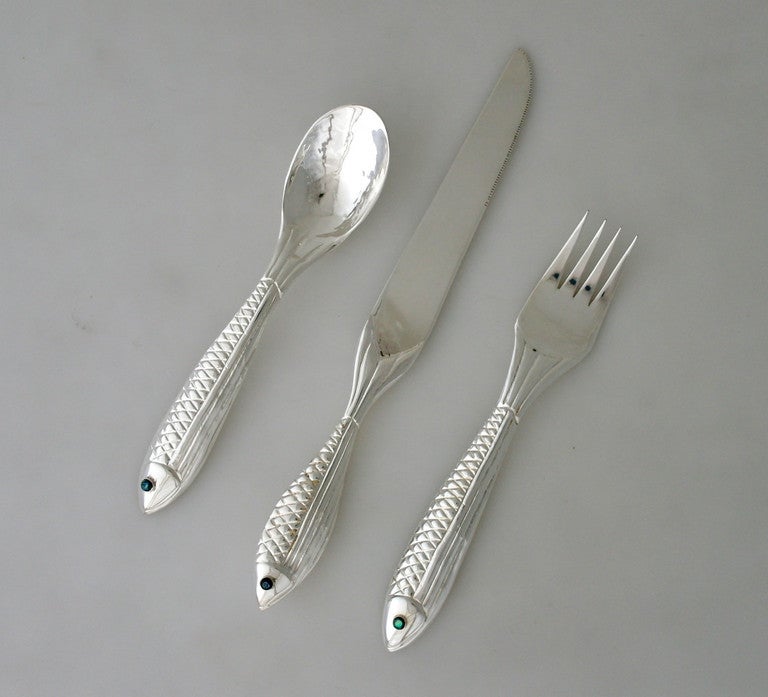 Being offered is a fine circa 1990 sterling silver dinner - luncheon set by Emilia Castillo, of Taxco, Mexico, in an aquatic motif, cast hollow handles in a fish motif realistically featuring scales and an abalone eye, the bowls of the spoons hand
