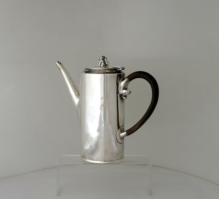 Being offered is a circa 1964 sterling silver three (3) piece coffee set by William Spratling of Taxco, Mexico, the sugar with cover, lidded creamer and coffee of oblate cylindrical form with graceful rosewood handles and crouching jaguar finials,