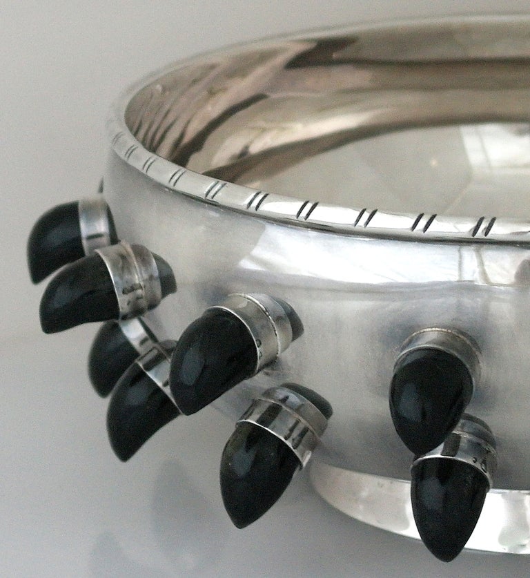 Being offered is a circa 1950s sterling silver centerpiece bowl by Tane of Mexico City,with twenty eight (28) jutting 7/8 inch tusk or horn shape jutting obsidian protrusions from body of bowl  This is arguably the most exciting piece of Mexican