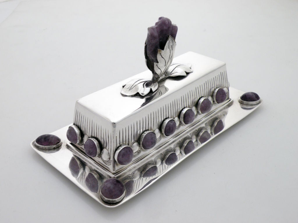 Being offered is a fine circa 1950 sterling silver and cabochon butter dish with cover by Marguerite Wenner for Conquistador, of Mexico, the tray with four (4) oval cabochon amethysts, the cover with fourteen (14) round cabochon amethysts, the cover