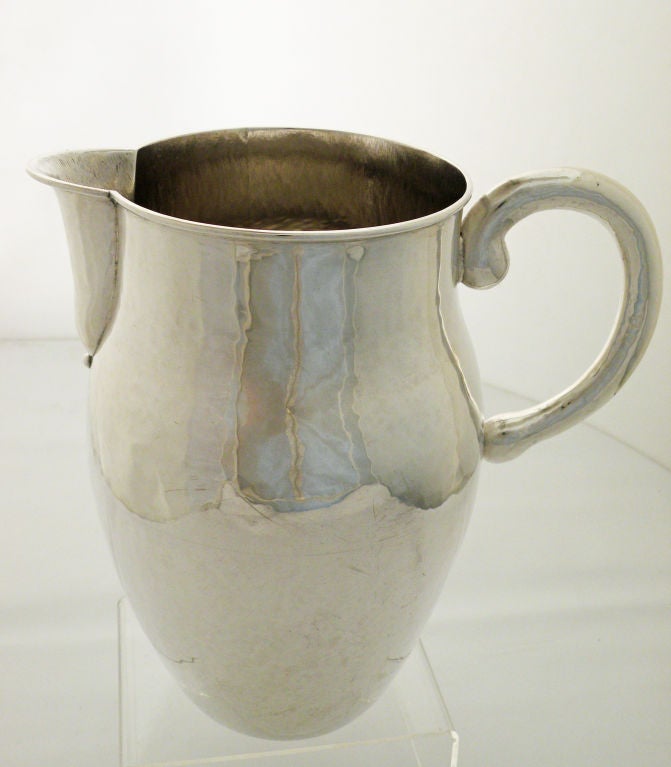 Being offered is a fine, circa 1950 sterling silver pitcher by William Spratling, of Taxco, Mexico, hand-wrought, the classical pitcher, with a central flared area at mid height, with applied handle. Marked as illustrated. No monogram. Dimensions 8