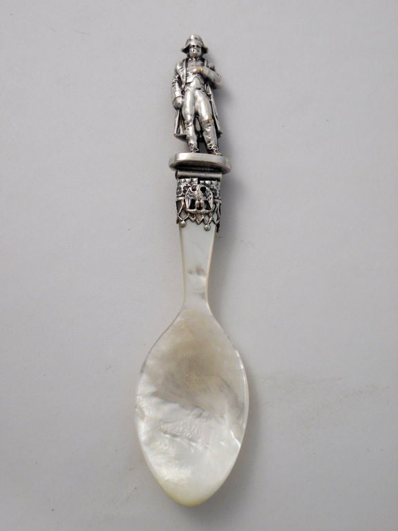 Being offered is a a fine silverplate and mother of pearl caviar spoon by unknown maker, the handle, a 3-dimensional image of Napoleon with Napoleon placing his hand under his jacket as is typically illustrated, with a French eagle also part of the
