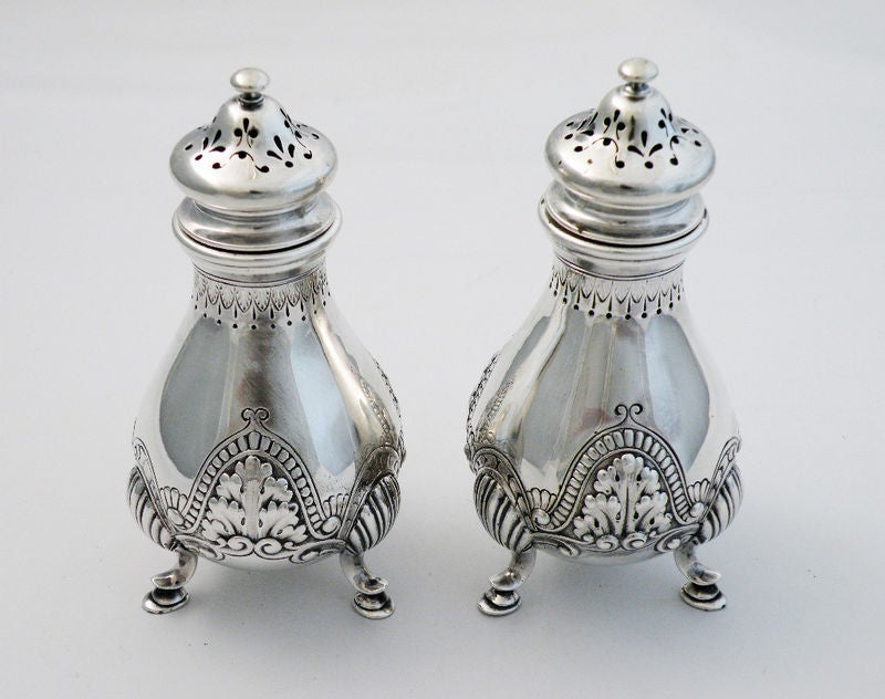 Being offered is a fine SPECIAL ORDER pair of circa 1896 sterling silver salt and pepper shakers by Gorham, of Providence, RI, the outer border chased and engraved in what appears to be a precursor to the Athenic pattern.  The leaves are the same as