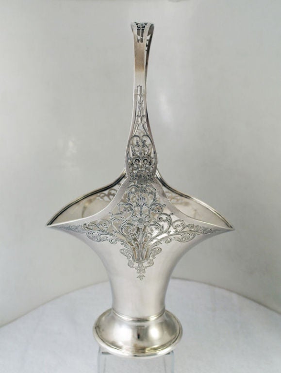 Being offered is a fine circa 1916 sterling silver 'bridal basket' by Gorham of Providence, RI, the handle body superbly pierced and engraved.   This is an exciting, utilitarian piece.  Dimensions 17 inches to top of handle by 10 inches across wider