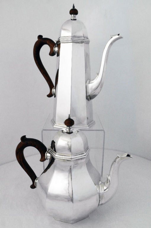 Being offered is a a fine circa 1950 handmade sterling silver coffee/tea service with tray by retailed by Cartier of New York and designed by Schroth, of Montville, New Jersey, in the moderne style, the tea and coffee service in an octagonal design