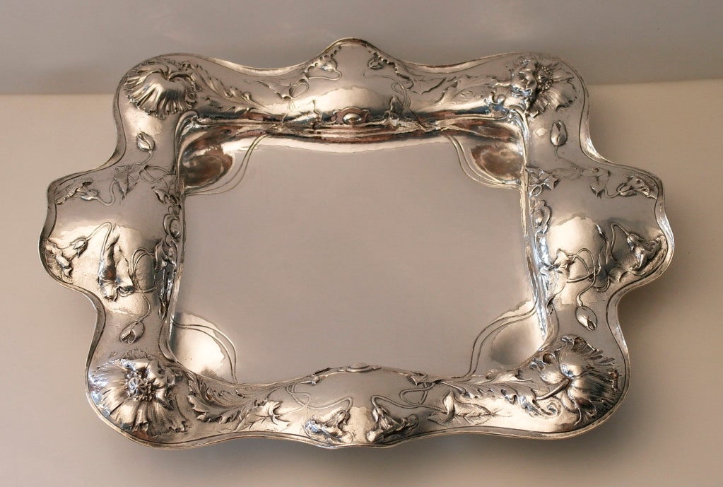 Being offered is an exceedingly rare circa 1905 sterling silver tray by Codman & Codman, of Providence, RI, handwrought, the firm's masterful chasing compared to martele, the rim in a high relief floral and foliate design (chased by hand). No