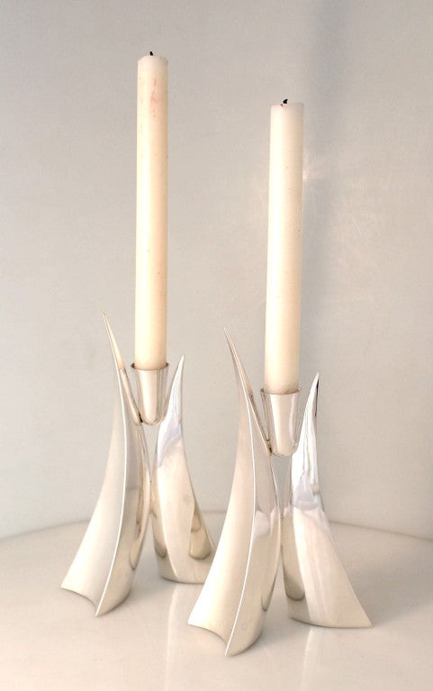 Being offered are a pair of Banner sterling silver candlesticks, hand wrought, in a contemporary, architectural motif.  The candlesticks are freeflowing, with a biomorphic shaped base, the shaft of each candlestick elevating in sleek undulating