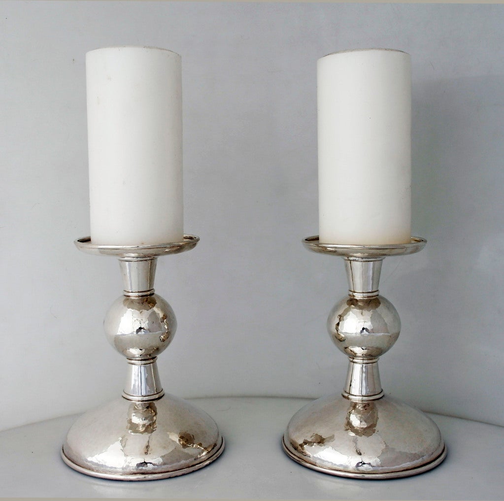 Being offered are a contemporary pair of one-of-a-kind sterling silver candlesticks - holders by award-winning silversmith/artist, Haddon Hufford, of Frenchtown, Montana, masterfully hand-wrought, the design includes a central ball in the column,