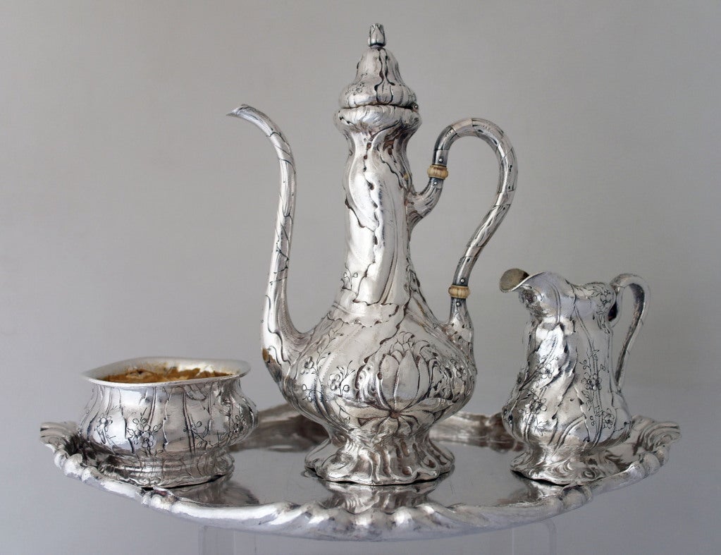 Being offered is fine four piece Martele 950/1000 silver coffee set with tray by Gorham of Providence, RI, and retailed by Spaulding & Co., Chicago, comprising a black coffee pot, cream jug and sugar bowl, each baluster form, chased with flowers,
