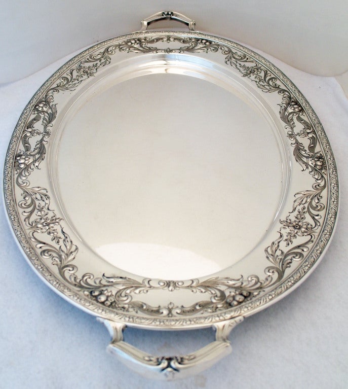 Being offered is a fine circa 1935 sterling silver serving tray - waiter - tea/coffee set tray by Ellmore Silver Co., Inc., of Meriden, CT, and retailed by Champlain of Denver, CO, the 2 1/2 wide border magnificently hand chased in a floral and