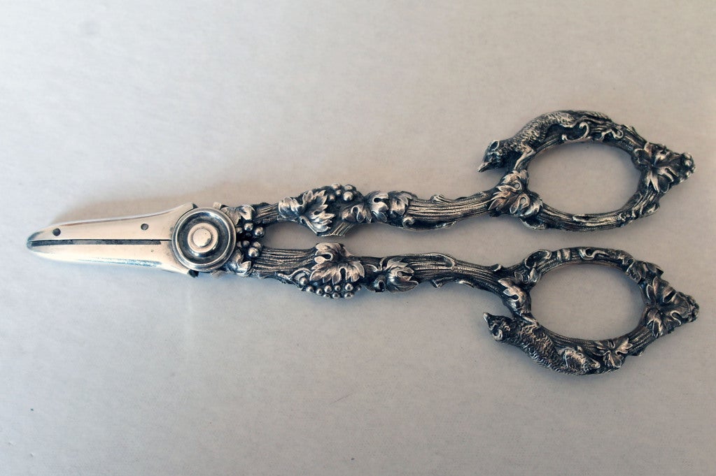 Being offered is an extraordinary pair of circa 1890 sterling silver grape scissors - shears by Gorham of Providence, RI, in the desirable H series design,  in a motif that includes grapes, leaves and cast foxes on the handles.  Weight a very hefty