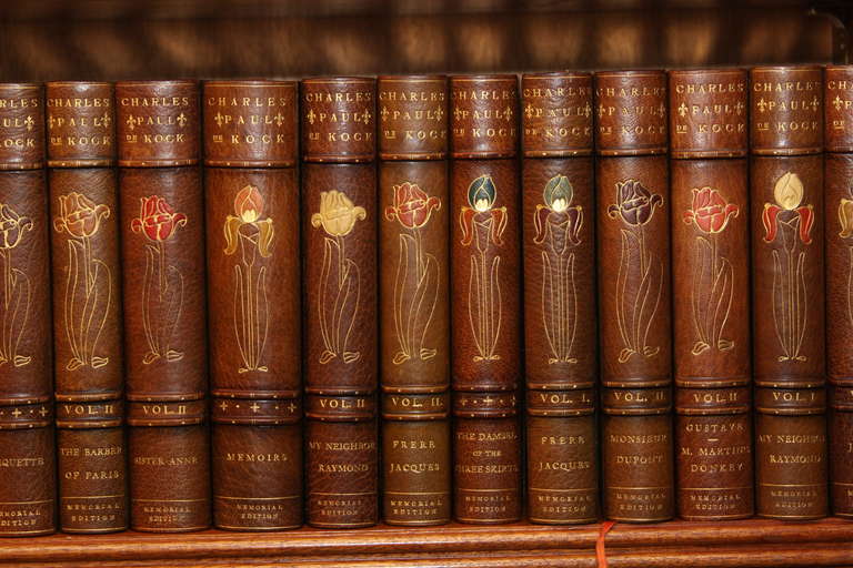 The complete writings of  Charles Paul De Kock.  25 volumes .  color text illustrated. Bound in three quarter green morocco faded to an even tan, spine  decorated of tulip design, raised band, marbled boards and endpapers, top edges gilt
