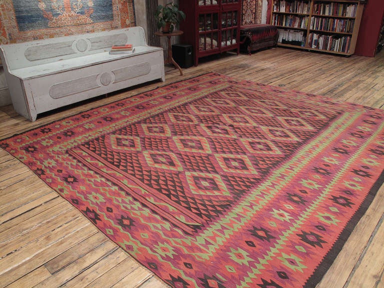 Large Manastir Kilim rug. An old Kilim rug from the Balkans, formerly part of the Ottoman Empire, where there is a centuries-old tradition of weaving large Kilims. This particular type of rug with its distinct design and color palette is attributed