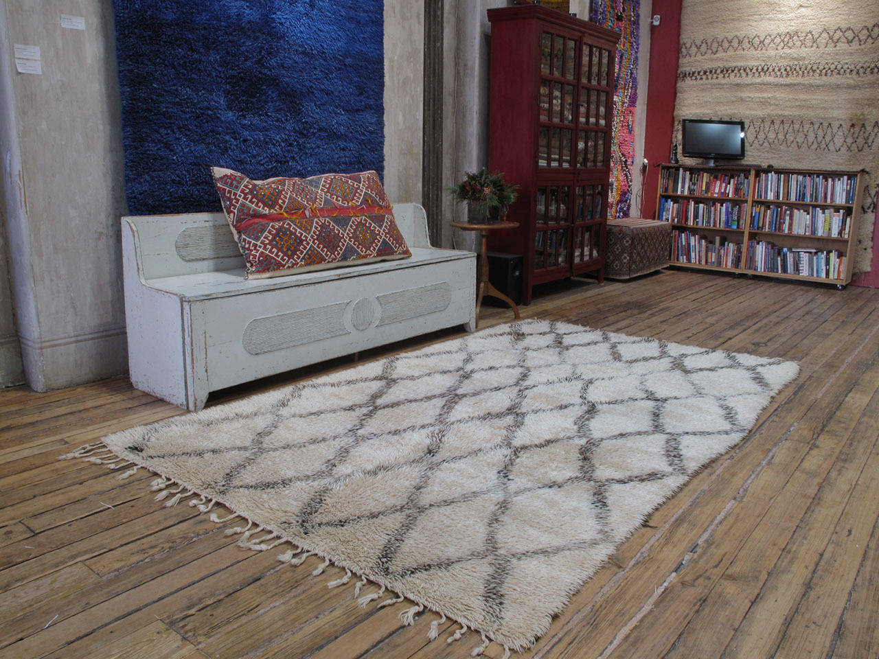 A very charming Moroccan Berber rug by the Beni Ouarain tribes of the middle Atlas Mountains, who used these large rugs as beds in their tents and cottages. The Classic diamond grid design is executed with pleasing irregularities. The wool has a